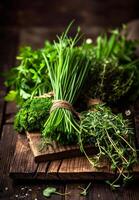 AI generated Fresh herbs and bunches of fresh green herbs on wooden table photo