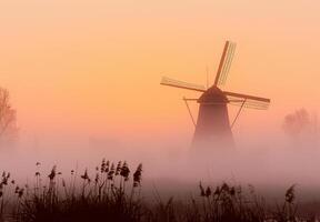 AI generated Windmill in foggy colorful sunrise in the countryside. photo