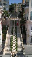 Woman in Vietnamese hat runs down the stairs in Sunset Town on Phu Quoc Island video