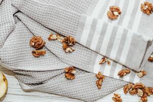 Fresh shelled walnuts on table with kitchen towel. photo