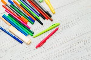 Stationery, colored felt-tip pens on a white table. photo