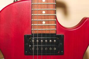 Red electric guitar with strings close up. photo