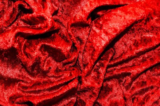 Texture of red velor corduroy fabric with folds photo