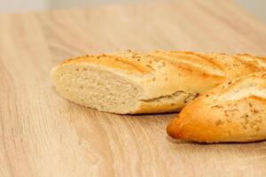 Fresh baguette made of white wheat flour with seeds and cereals photo