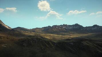 A majestic mountain range with wisps of clouds floating in the sky video