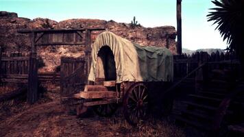 A vintage covered wagon in a rustic countryside setting video