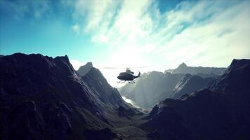 A helicopter is flying over a mountain range video