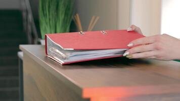 Accountant puts a folder with documents on the table close-up video