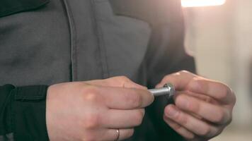 Service. Close-up of the craftsman tightens the nut and bolt with his hands. Selection of nuts and bolts. video