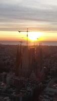 verticaal video van sagrada familia kathedraal, in Barcelona Bij zonsopkomst antenne visie