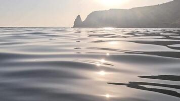 Sea water surface. Low angle view over clear azure sea water. Sun glare. Abstract nautical summer ocean nature. Holiday, vacation and travel concept. Nobody. Slow motion. Weather and climate change video