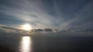 Timelapse fluffy Cumulus clouds moving in bright golden sunset sky over sea. Abstract aerial nature summer ocean sunset, sea and sky view. Vacation, travel, holiday concept. Weather and Climate Change video