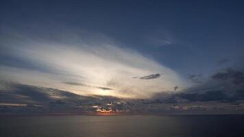 Timelapse fluffy Cumulus clouds moving in bright golden sunset sky over sea. Abstract aerial nature summer ocean sunset, sea and sky view. Vacation, travel, holiday concept. Weather and Climate Change video