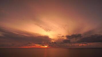 Timelapse fluffy Cumulus clouds moving in bright golden sunset sky over sea. Abstract aerial nature summer ocean sunset, sea and sky view. Vacation, travel, holiday concept. Weather and Climate Change video