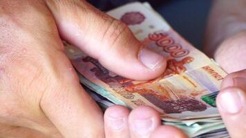 Man hands counting money, close-up. Financial literacy concept, counting paper banknotes, Russian rubles. Unrecognizable person, male hands, outdoor scene video