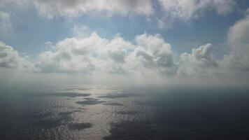 Aerial view. The drone flies over foggy and fluffy clouds. Blue sky sun and sea fog. Abstract aerial nature summer ocean sunset sea and sky background. Vacation, vacation and holiday concept video