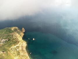 Aerial view. The drone flies over foggy and fluffy clouds. Blue sky sun and sea fog. Abstract aerial nature summer ocean sunset sea and sky background. Horizon. Vacation, travel and holiday concept photo