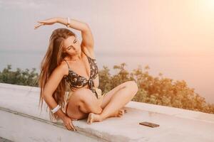 Woman park yoga. Side view of free calm bliss satisfied woman with long hair standing in morning park with yoga position against of sky by the sea. Healthy lifestyle outdoors in park, fitness concept. photo