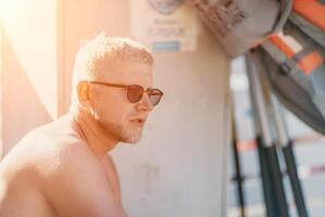 Outdoor portrait of mid aged smiling Caucasian man in sunglasses photo