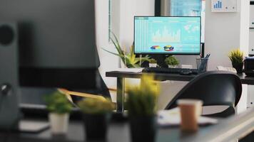 Computer screen in business office shows stock exchange values changing in real time. Desktop PC monitor in workplace with trading indexes showing prices and pie charts graphs video