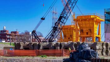 A timelapse of moving cranes at the under construction telephoto shot video