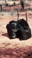 closeup of full trash bags on the sand video