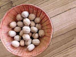 Walnuts in shell on wooden background video