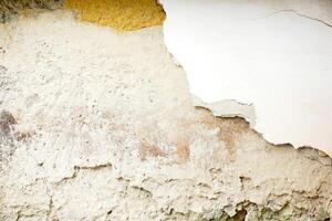 Background and texture of ancient and old house cracked cement wall in natural sun lights. photo