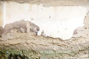 Background and texture of ancient and old house cracked cement wall in natural sun lights. photo