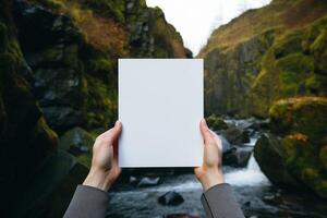 AI generated A person standing in front of a waterfall, holding a card in their hand. photo