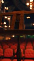 An empty theater with red seats and chandeliers video