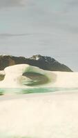 A large iceberg floating in the middle of a lake video