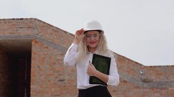 Female architect in business attire stands in a newly built house with tablet. Modern technologies in the oldest professions video