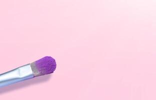 two cosmetic brushes with pink powder isolated on white , place for text photo