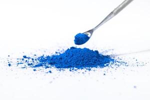 ultramarine pigment, dry paint on a white background, macro photo