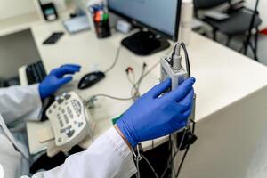 Electromyography in doctor s hands. Medical examination. EMG. Selective focus. photo