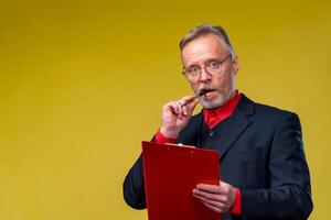 Old man in glasses with documents, folder, confident businessman. Reading contract photo