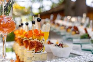 Banquet event. Table with glasses, snacks and appetizers. Celebrating event. Blurred background. photo