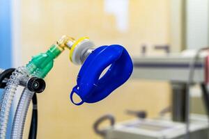 Oxygen mask as part of artificial lungs ventilation machine in surgery room, closeup. COVID-19 and coronavirus identification. Pandemic. photo