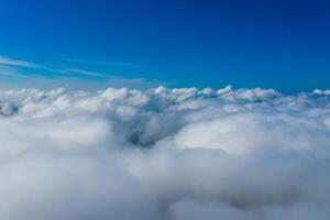 blanco nubes ver desde el ventana de un avión. nubes abajo y azul cielo arriba. foto