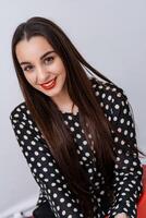 Smiling young woman with healthy teeth looks to the camera. Selective focus. Cropped photo. photo