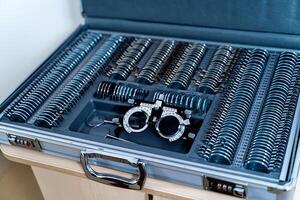 A trial frame with set of corrective lenses. Test vision equipment. Ophthalmology tool box. photo