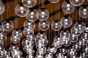 A group of hanging lights with shallow depth of field. Many celling lamps. photo