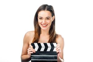 Girl with clapper board. People's emotions. Isolated background. Close up. Beauty with film numerator. Brunette with nice smile. Closeup. photo