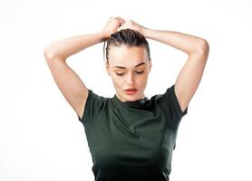 Attractive woman holding hair high above head. Happy and funny girl. Isolated white background. photo