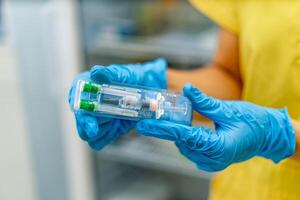 Doctors hands hold vaccination in hands. Selective focus. Prevention, anti-flu concept. Blurred background. photo