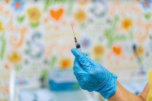 Syringe with medicine in hand for injection. Prevention and health care concept. Close-up photo