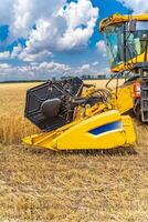 Selective focus on part of harvest gathering machine. Harvest time. Special technic in field. photo