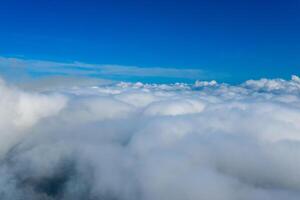Many endless clouds in fantastic blue sky. Clouds below the sky. Cotton clouds under the sky. photo