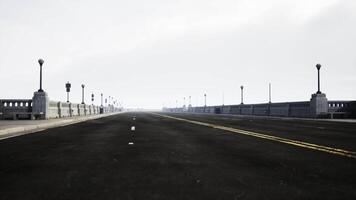 An empty illuminated asphalt road in a thick fog video